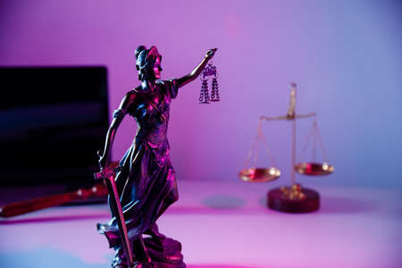 Law concept. Bronze statue Lady Justice holding scales and sword in notary officeの写真素材