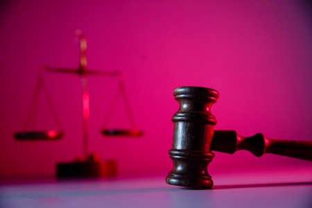 Scales of justice and wooden gavel in courtroom. Law conceptの写真素材