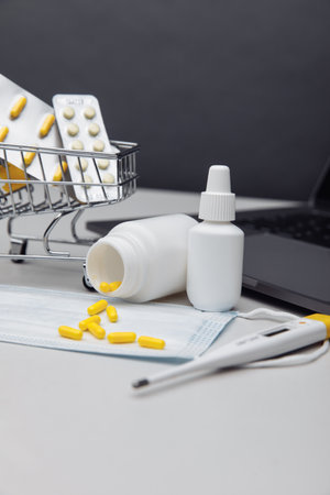 Small shopping cart with pills. Online purchase of medicines concept. Vertical image