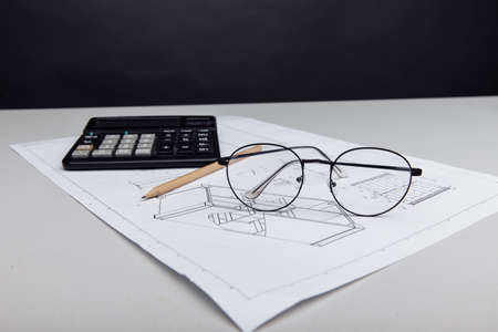 Architectural plan, glasses and calculator. Building costの写真素材