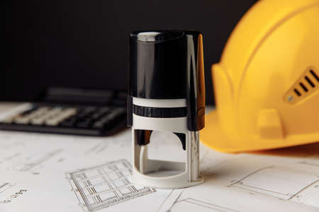 Project blueprint with helmet and stamps