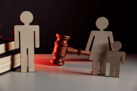 Wooden model of couple and judge gavel. Divorce conceptの写真素材