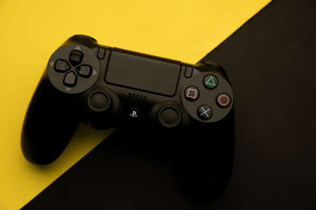 Tula, Russia - April 08, 2021: Sony Dualshock 4 on black and yellow backgroundのeditorial素材