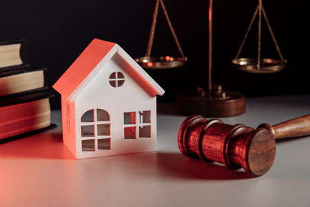 Real estate concept. House model and gavel close-upの写真素材