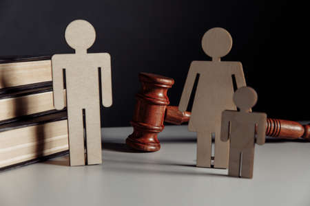 Wooden model of couple and gavel on a table. Divorce conceptの写真素材