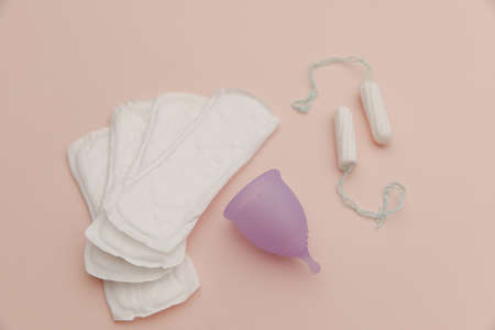 Pad, menstrual cup, tampon on a pink background. Concept of critical days and hygieneの写真素材