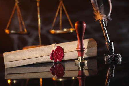 Document with wax seal, scales and stamp in notary office. Law of legacy concept