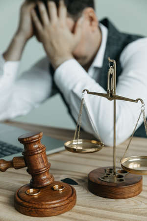Divorce concept. Judge gavel and wedding rings. Top view