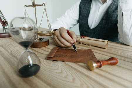 Male lawyer working with contract papers and wooden gavel on tabel in courtroom. justice and law ,attorney, court judge, concept.の写真素材