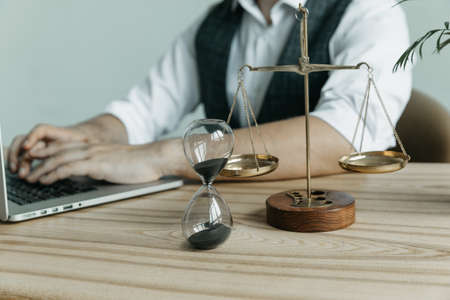 Male lawyer working with contract papers and wooden gavel on tabel in courtroom. justice and law...
