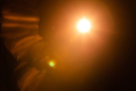 Solar lens flare on black backgroundの写真素材