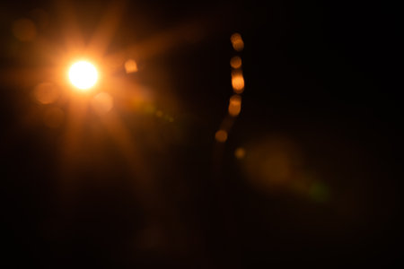 Solar lens flare on black backgroundの写真素材