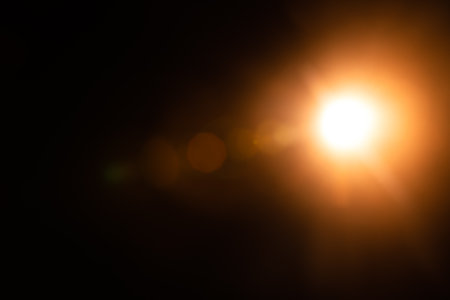 Solar lens flare on black background.の写真素材