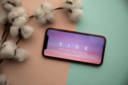 Tula, Russia - September 07, 2021: Tide app logo on iPhone displayのeditorial素材