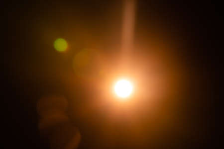 Solar lens flare on black backgroundの写真素材