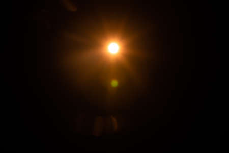 Solar lens flare on black backgroundの写真素材
