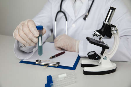 Scientist or medical in lab coat working in biotechnological laboratory. Microscope equipment for research and test tubeの写真素材