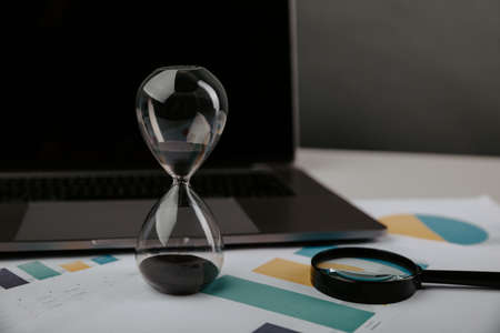 Hourglass on a keyboard. Time management concept.の写真素材