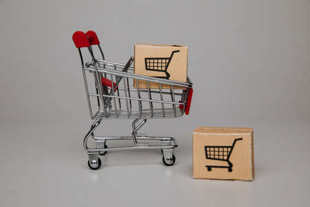 Mini shopping cart with shipping paper boxes. Shopping and delivery conceptの写真素材