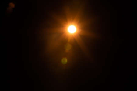 Solar lens flare on black backgroundの写真素材