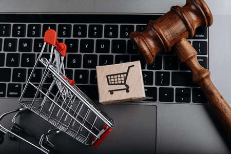 Consumer right concept, judge gavel, grocery cart and card boxの写真素材
