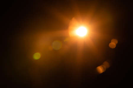Solar lens flare on black backgroundの写真素材