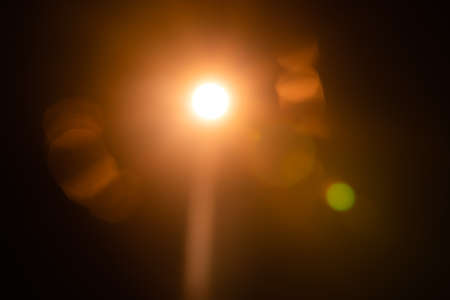 Solar lens flare on black backgroundの写真素材