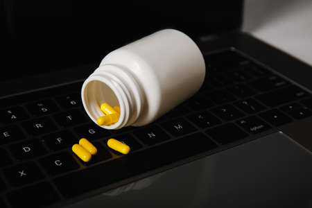 Online pharmacy concept. Pills on a laptop close-upの写真素材