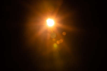 Solar lens flare on black backgroundの写真素材