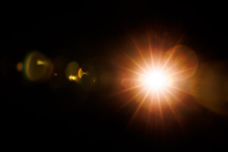 Abstract Natural Sun flare on the black background.の写真素材