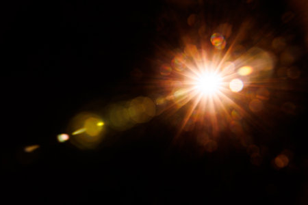 Abstract Natural Sun flare on the black background.