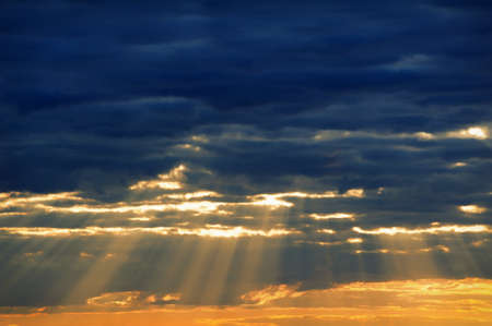 A ray of sunlight breaking through dark clouds.