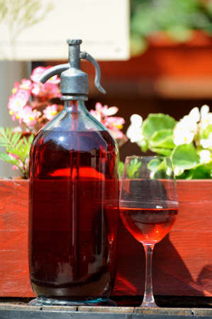 Wine in old bottles on a barrel.の写真素材