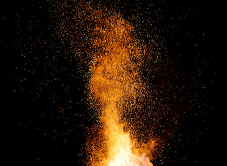 smithy fire flame tips with sparks closeup on dark background