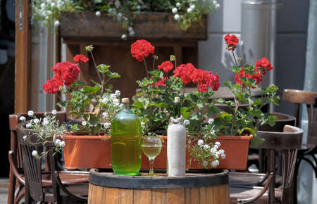 Wine in old bottles on a barrel.の写真素材