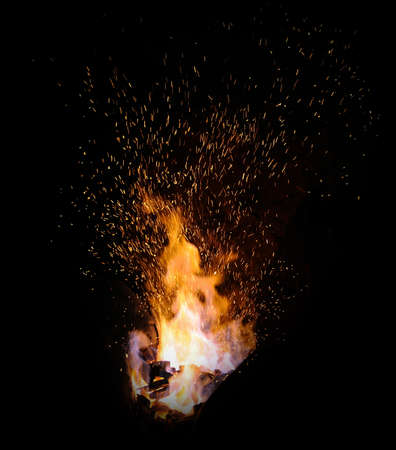 smithy fire flame tips with sparks closeup on dark backgroundの写真素材