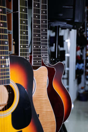 Colorful acoustic guitars  in the store background