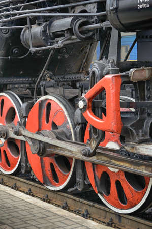 Train drive mechanism and red wheels of an old soviet steam locomotiveの写真素材