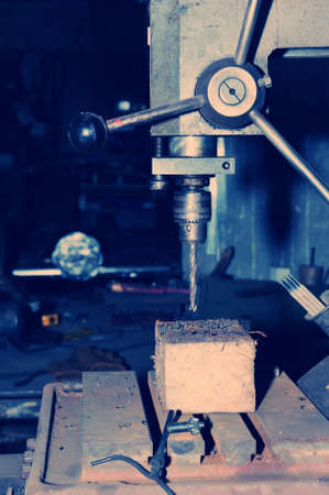 An old industrial electric heavy drill head in a factory for metal and wood drillingの写真素材