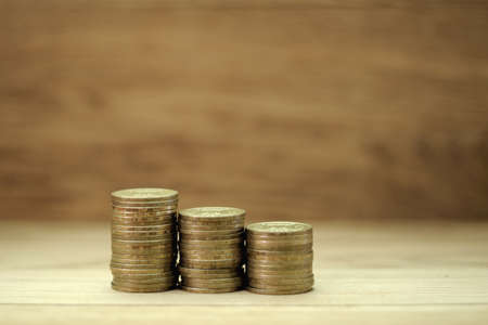Coins on a wooden background close up