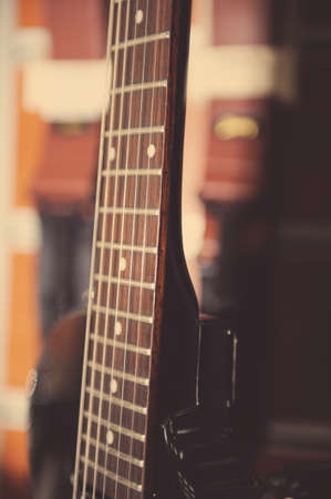 Electric guitar fingerboard against colorful backgroundの写真素材