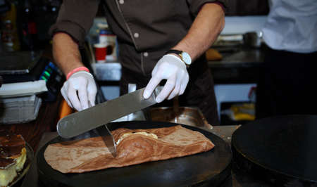 the chef prepares a pancake close upの写真素材
