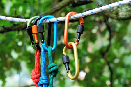 Carabiner with rope on nature background. Climbing uquipment.Climbing sports image of a carabiner on...