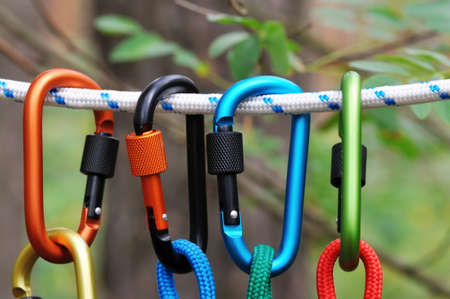 Carabiner with rope on nature background. Climbing uquipment.Climbing sports image of a carabiner on...