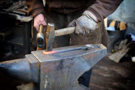 The blacksmith kicks a horseshoe close up .の写真素材
