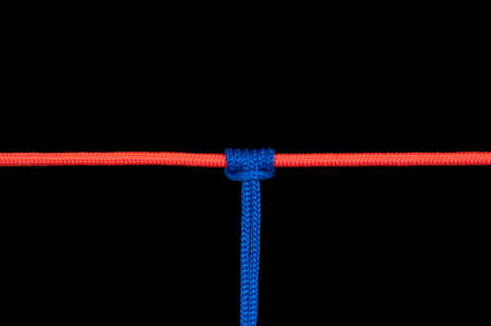 Knot on a cord on a dark background .