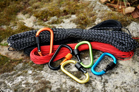 Metal carabine and rope for mountaineering. Photo of colored carabines and rope. Climbing conceptの写真素材