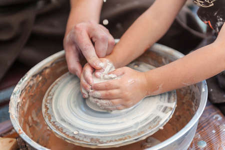 Master class on modeling of clay on a potter's wheel In the pottery workshopの写真素材