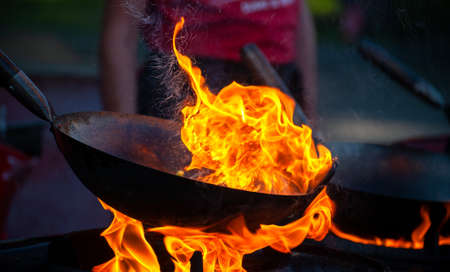 Cooking street food on a hot frying pan. Street food festival