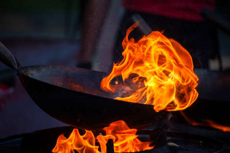 Cooking street food on a hot frying pan. Street food festivalの写真素材